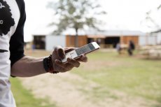 man using ShopKeep point of sale pocket application to access store data, anytime, anywhere.